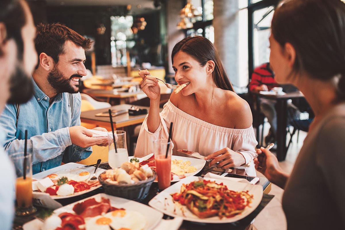 A group of Happy friends having breakfast in the restaurant
