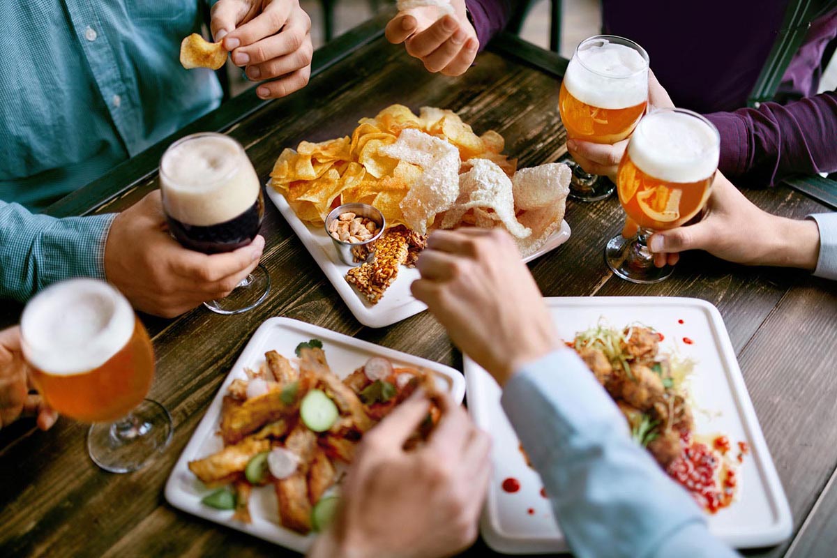 Restaurant table with beer and food closeup
