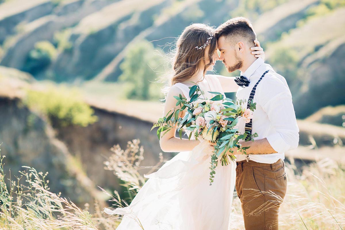Bride and groom in the breathtaking grass fields