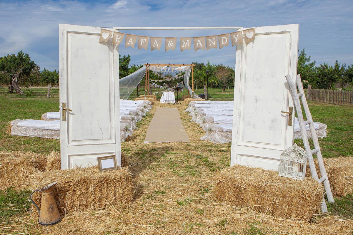 Wedding venue setting depicting a rural farm field and haystacks